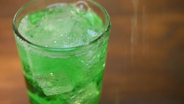 Air Bubbles Inside Glass of Sparkling Green Water