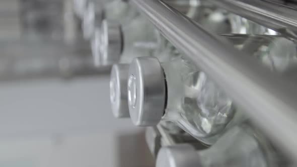 Vertical Video Glass Bottles Filled and Sealed with Rubber and Aluminum Caps on Medical Solution