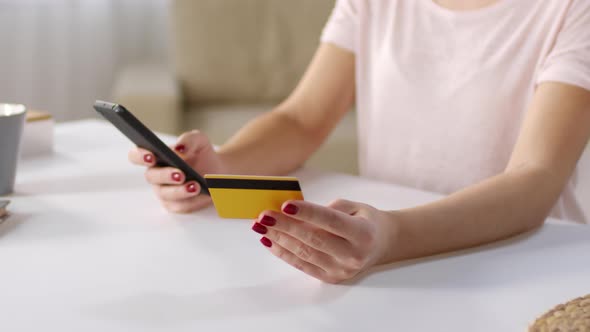 Woman Paying for Goods with Smartphone Application alt