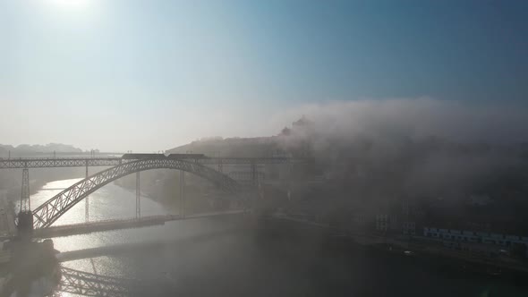 Porto Aerial Cityscape with Luis I Bridge and Douro River at Fog Portugal