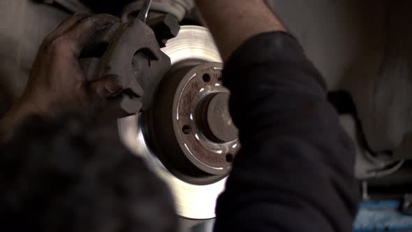 Replacing Old Brake Discs Of A Car In A Repair Shop alt