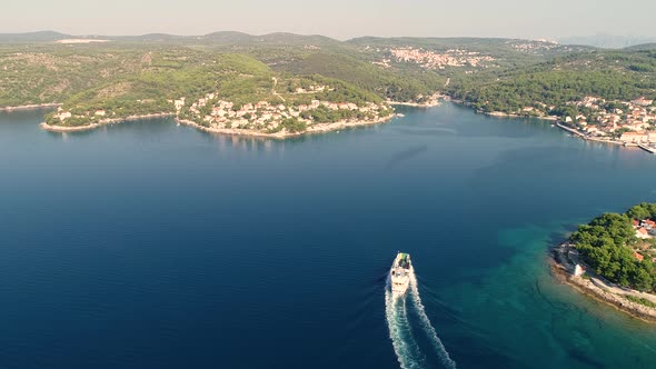 Aerial view of ferry boat approaching Sumartin port, Brac island, Croatia. alt