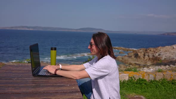 The Girl Behind the Laptop By the Ocean alt