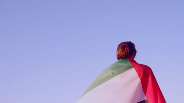 United arab emirates flag on the shoulders of a young brunette woman