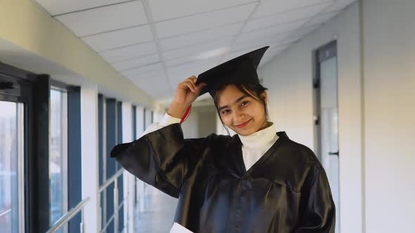 Indian Female Graduate in Black Gown and Wearing Master's Hat in University alt