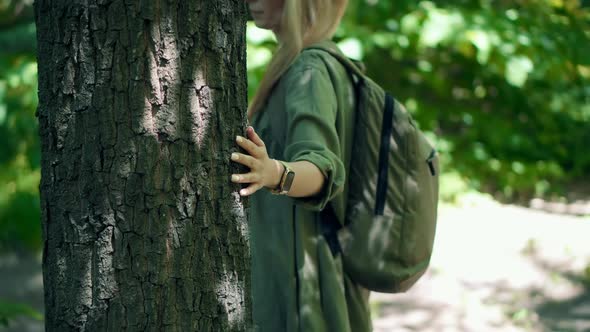 Girl In Dress Walking In Greenwood.  Female Exploring Green Forest In Sunny Time. alt