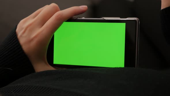 Green screen on smart phone while scrolling through pages 4K 2160p UHD footage - Looking to cell pho alt