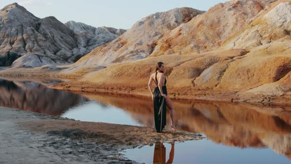 Beautiful woman posing on other-worldly hilly landscape