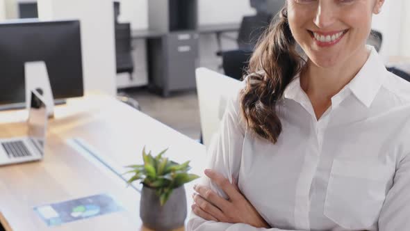 Portrait of female executive standing with arms crossed 4k alt