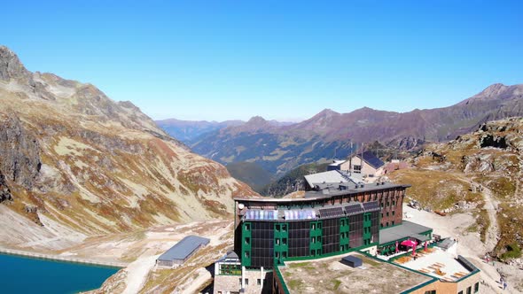 Casual Hotel Of Berghotel Rudolfshutte At The Waterfront Of Weisssee In Salzburg, Austria. aerial alt