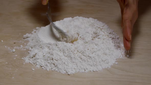Hands Mixing Flour With Eggs For Pasta Dough 38