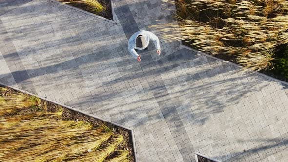 A Middleaged Man Dancing Braidance on the Street alt