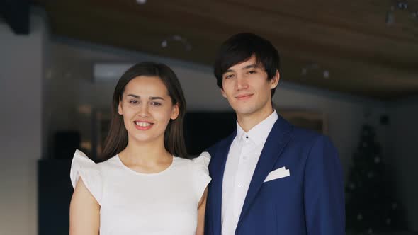 Portrait of Beautiful Young Couple Man and Woman in Fancy Clothing Standing Together in Restaurant alt