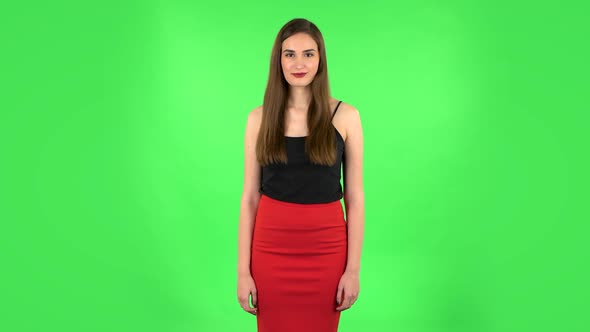 Female Listens Attentively and Nods His Head Showing Finger Gesture No, Then Smiling. Green Screen alt