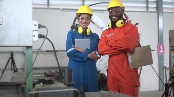 engineer cooperation male and female technician maintenance control relay robot arm alt