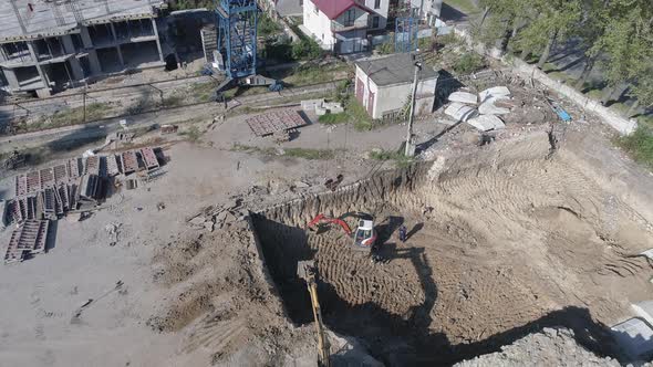 Aerial of a building's foundation and a tower crane alt