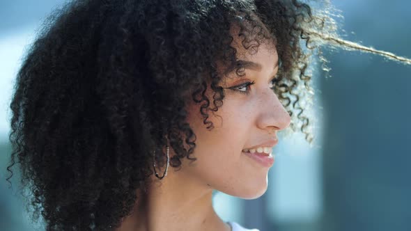 Face Portrait of Cute Positive Pretty African Young Brunette Woman Model with Long Curly Hairstyle alt