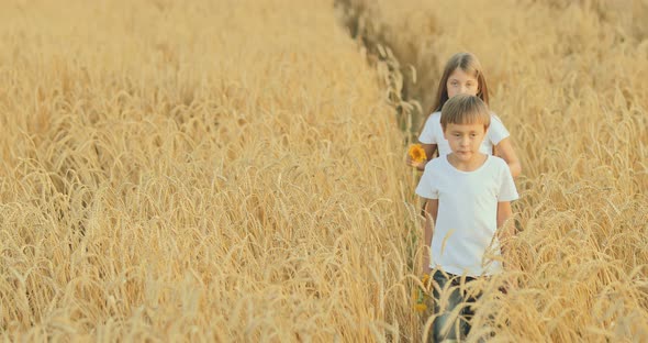 Boy and Girl Walk Across the Field and Sing Songs