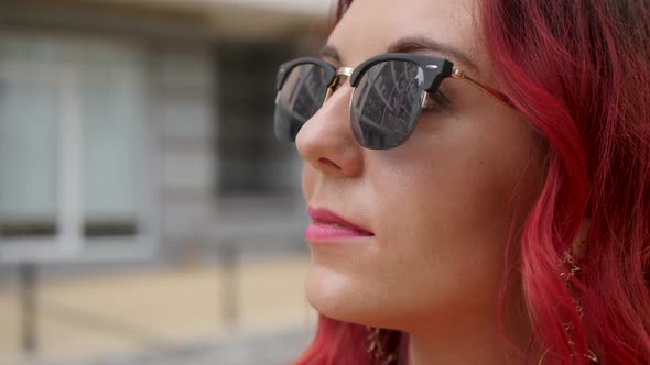 Red-haired Woman in Sunglasses