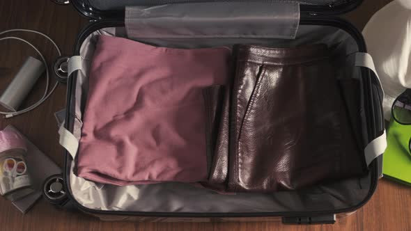 Timelapse Man and a Woman Packing a Suitcase or Luggage for Travel. Concept. A Man and a Woman alt