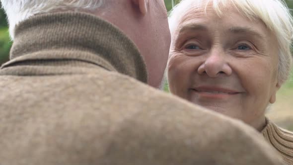 Grey-Haired Man Kissing His Mature Wife on Cheek, Romantic Moments, Happiness