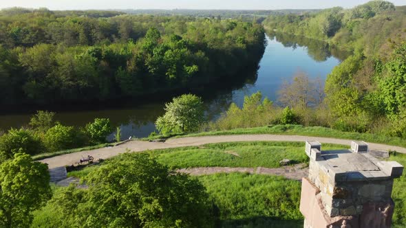 Aerial Drone View Flight Over Glade Bright Green Grass and Stone Old Tower alt