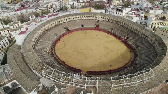 Plaza de Toros or bullring and cityscape with cathedral in background, Seville in Spain