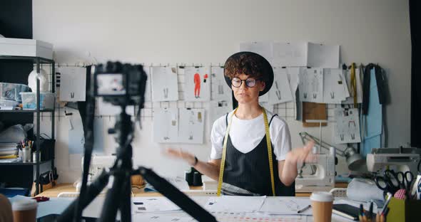 Attractive Girl Fashion Designer Recording Video for Internet Blog About Clothes alt