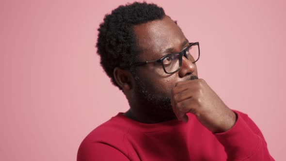 Meditative adult African man looking to the side alt