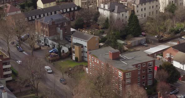 Aerial view of houses in Surbiton, London, UK with a pan up reveal of the river Thames. alt