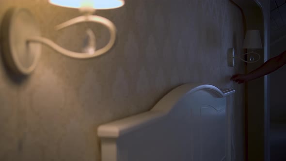 Bedroom Interior in the Evening Turning on Lamps Next to the Bed alt