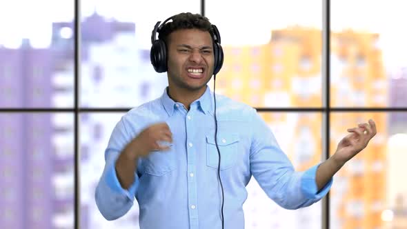 Young Darkskinned Man with Headphones Listening To Rock Music alt