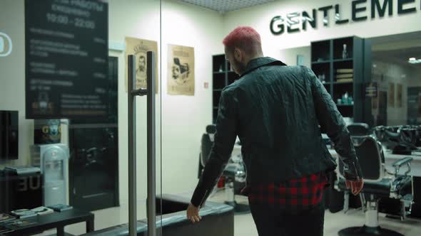The Client Enters the Barbershop and Sits in a Chair for Waiting alt