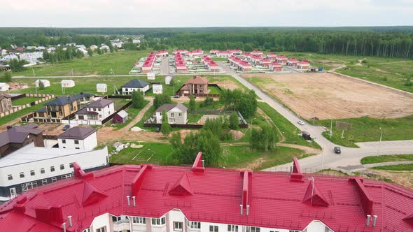 Flight Over the Red Roof of Highrise Buildings Townhouses in the Suburbs alt