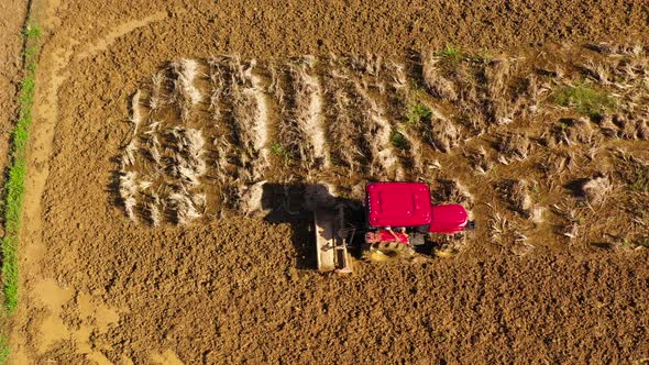 The Tractor Plows the Land alt