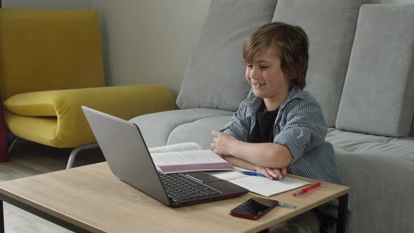 Smiling Boy Attend Online Lesson Using Laptop for Elearning on Pandemic Quarantine Doing Homework