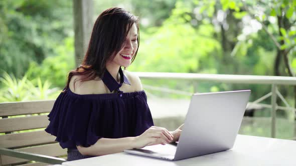 happy woman using laptop computer