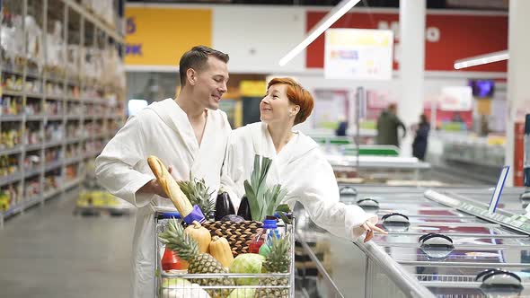 European American Family Couple in Bathrobe Happy to See Many Discounts in Grocery Store