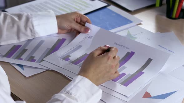 Paperwork and Sale Concept Female Hands with Pen Filling Papers alt