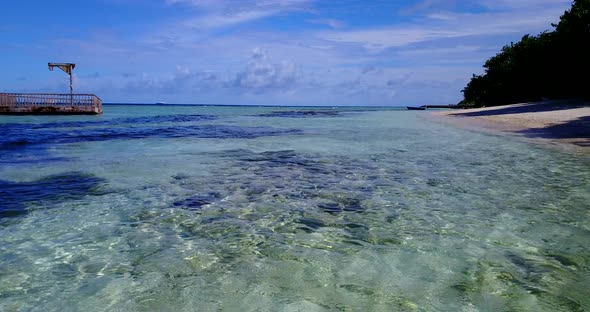 Wide birds eye clean view of a white sand paradise beach and turquoise sea background  alt