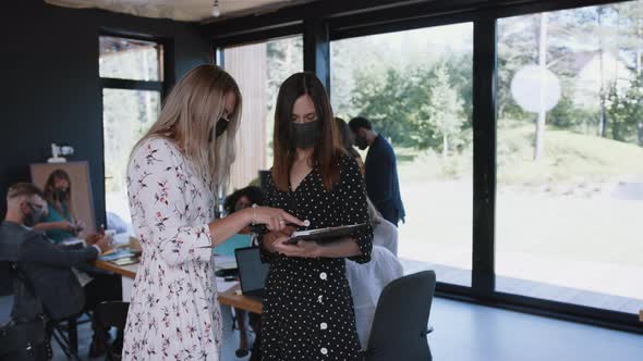 COVID-19 Safety As a Lifestyle. Happy Young Business Colleagues Women Greet with Elbows at Workplace