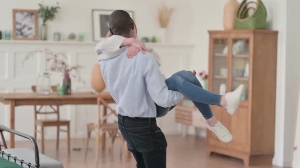 Close Up of African Man Swirling While Having Caucasian Woman in Arms alt