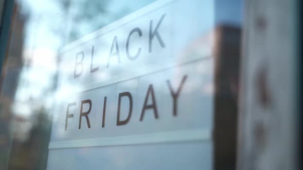 Lightbox Sign Black Friday Behind a Glass Door of the Cafe. Concept Black Friday, Season Sales Time