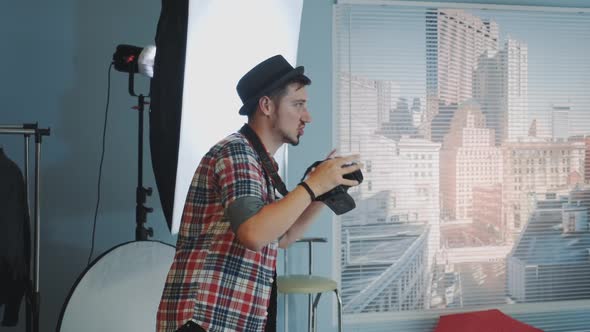 Young Photographer in Casual Clothes Explaining Something and Starting Taking Photos alt