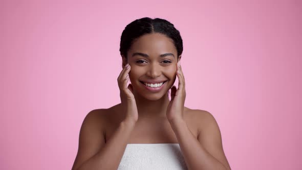 Studio Portrait of Happy Beautiful African American Lady Wrapped in Towel Touching Her Face Smiling alt