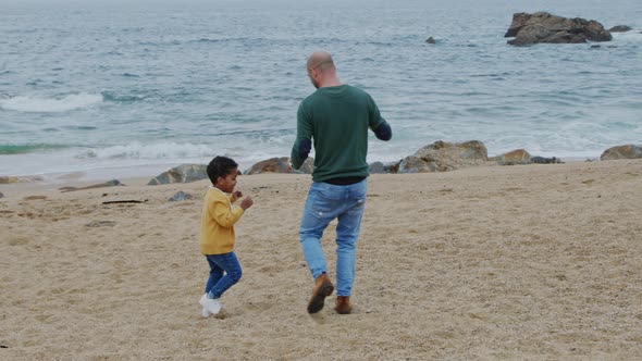 Father Is Having Fun With Son On Beach