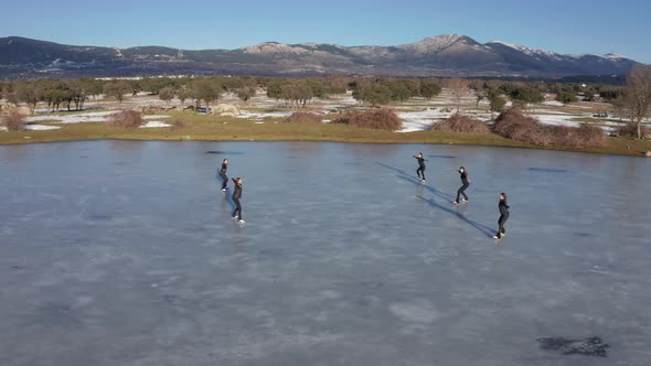 Group of young women firgure skating on frozen lake