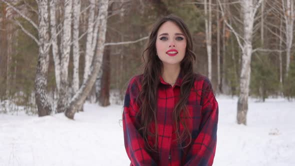 Charming Female with Long Hair Walking in Snowy Forest