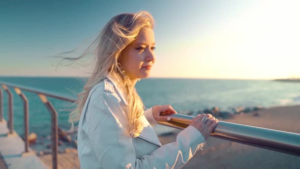 Woman Walking Along Beautiful Beach Bridge Terrace at Sunset alt