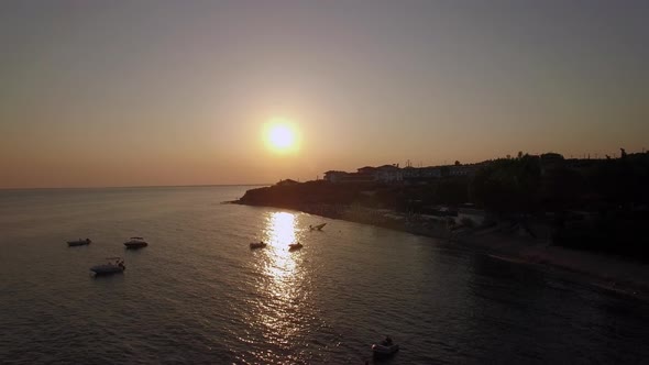 Sunset Scene of Resort and Sea with Boats, Aerial. Trikorfo Beach in Greece alt